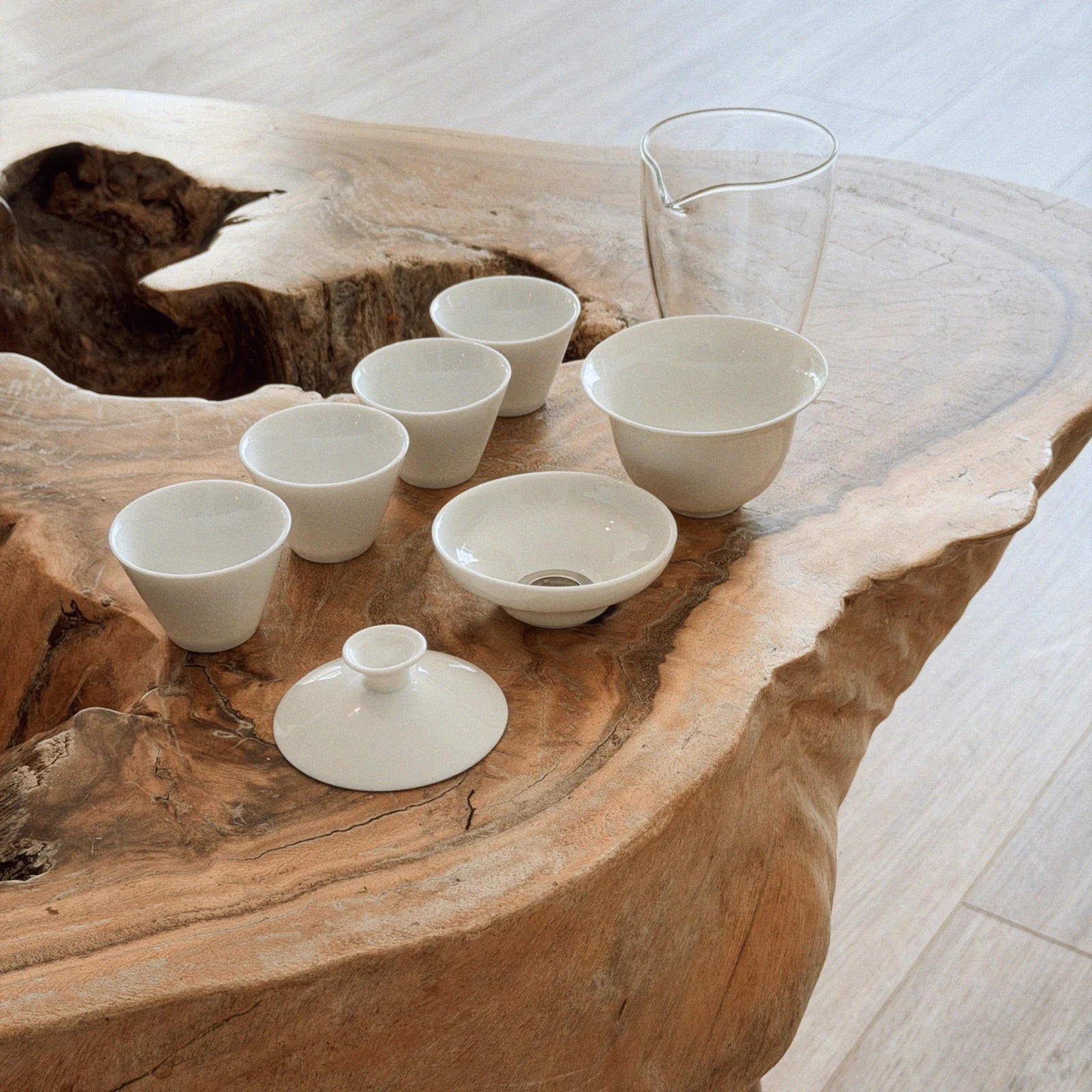gaiwan tea set with cha hai strainer and 4 white cups on natural wooden tray
