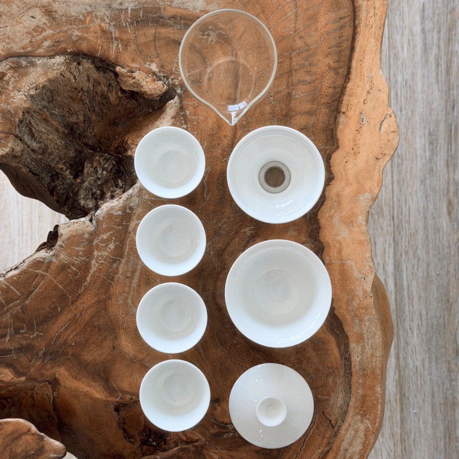 complete gaiwan set components laid flat — gaiwan, cha hai, strainer, and 4 cups top view