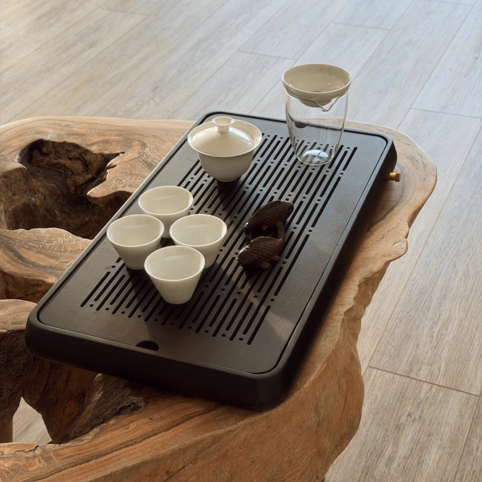 Black chaban tea tray large with white gaiwan cups set on wooden surface