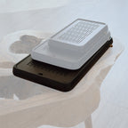 Large black tea tray chaban on light stone surface minimalist style