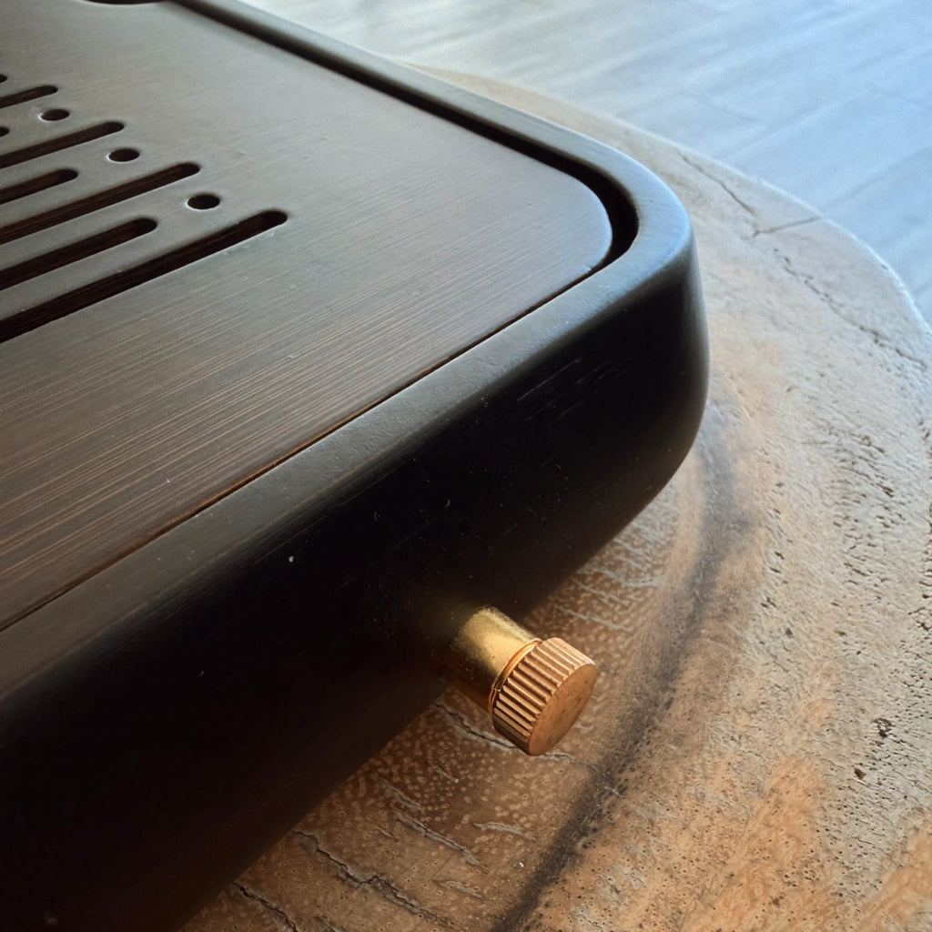 Close up of black chaban tea tray drainage holes and side drain spout detail